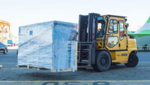 Truck delivering pallets to modernization project