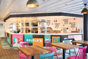 Restaurant interior labeled 'Abuela’s Mexican Dishes' featuring colorful tiles, modular food service counter, and vibrant seating—designed for marine catering, offshore dining, and cruise ship hospitality by ALMACO.