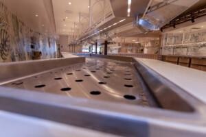 Stainless steel buffet counter with ventilation holes in modern marine galley or offshore dining area – ALMACO catering solution