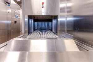 Hobart commercial dishwasher with stainless steel conveyor system for marine and offshore galley solutions by ALMACO