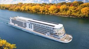 Viking river cruise ship sailing through autumn landscape, showcasing modern marine accommodation and catering areas—aligned with ALMACO’s turnkey outfitting solutions for river and expedition vessels.