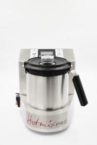 HotmixPRO stainless steel kitchen appliance with transparent-lid mixing container and ergonomic handle – professional-grade food processor for precision blending and cooking.