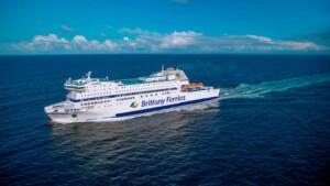Brittany Ferries vessel sailing on calm open sea under a partly cloudy sky, showcasing ALMACO’s turnkey marine outfitting and modular accommodation solutions for passenger ferries.