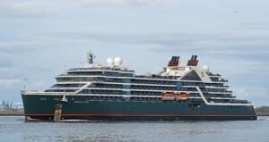 Seabourn Venture luxury expedition cruise ship sailing near industrial port, featuring ALMACO’s turnkey marine outfitting and modular accommodation solutions for high-end exploration vessels.