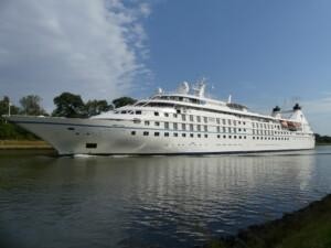 Star Legend cruise ship sailing on calm waters with trees and partly cloudy sky in the background, showcasing ALMACO’s turnkey marine outfitting and modular accommodation solutions for luxury vessels.